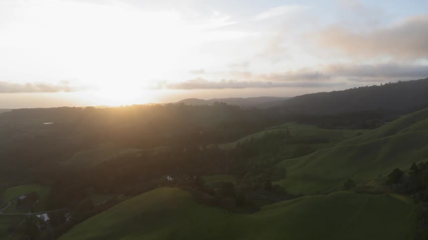 Landscape of green hills at sunset