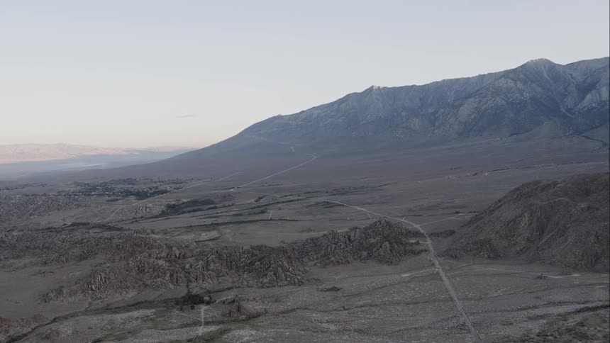 A road through a gray and rocky landscape