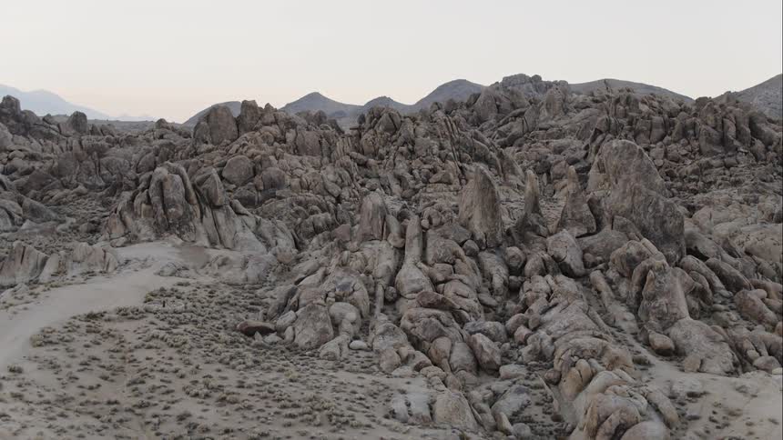 Large piles of rock in front of hills