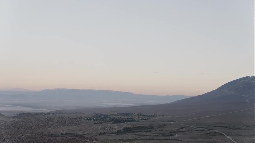 Town occupies valley between low mountains and badlands