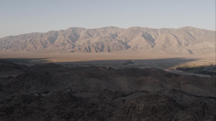 A desert valley between two mountain ridges
