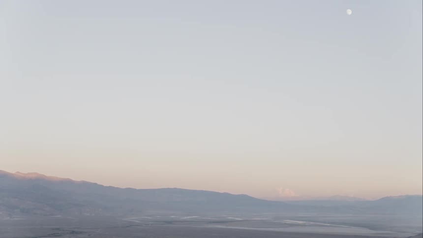 Landscape view of flat land with hills in the background