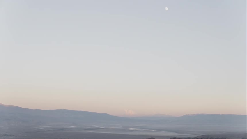 Aerial view of flat land with hills in the background