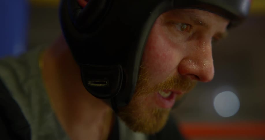 Boxer breaths heavily and takes out mouth protection