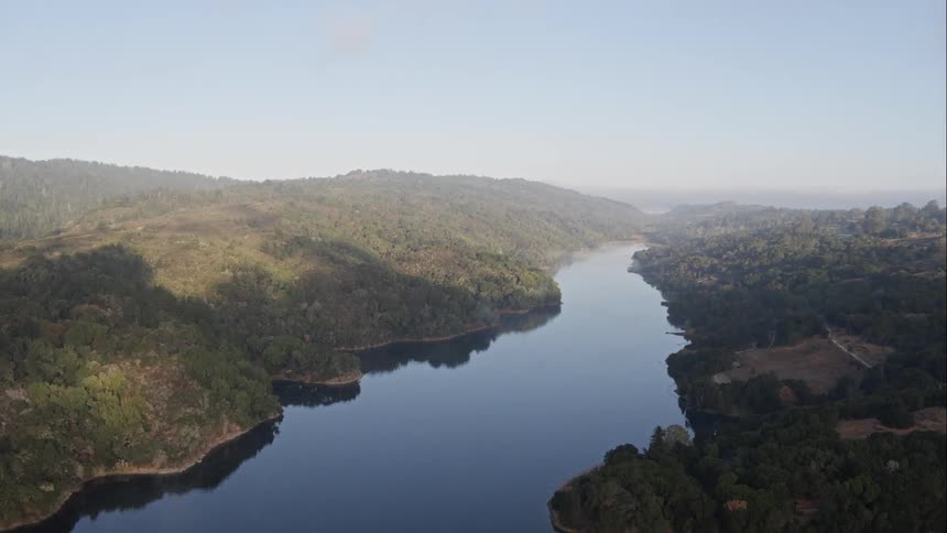 Peaceful aerial view of river in the valley