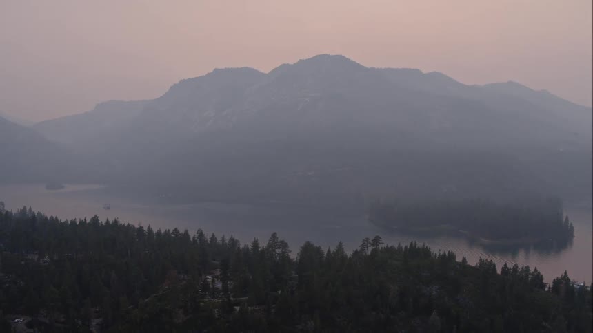 The heavy fog covers the river at dawn