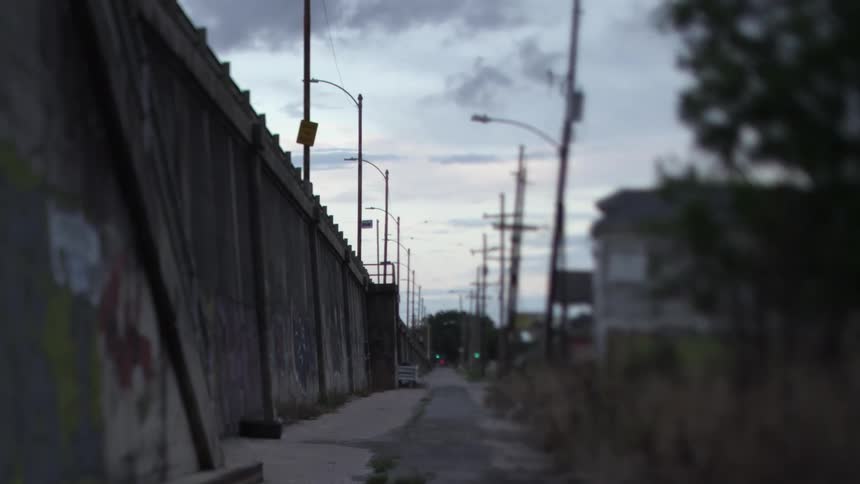 View of a sidewalk with light poles on a cloudy day