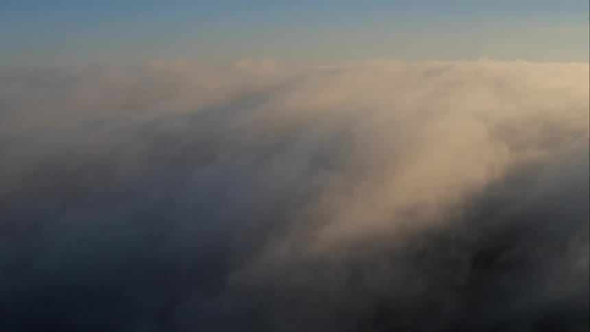 The heavy clouds cover the surface below