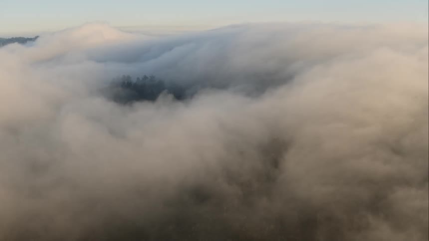 Clouds cover the landscape below