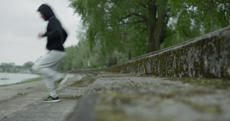 Athlete running up and down stairs by the water