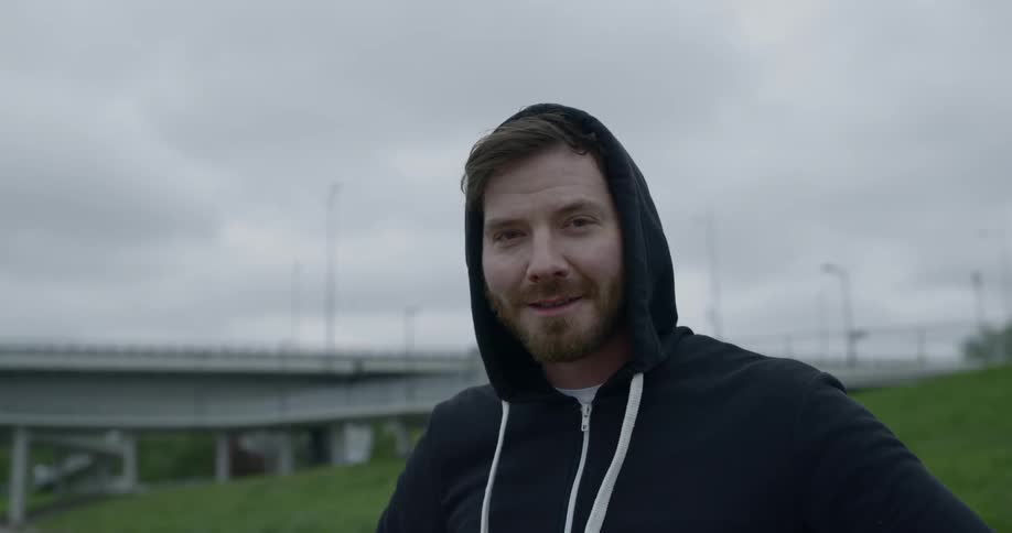 A man looking towards the camera and smirking