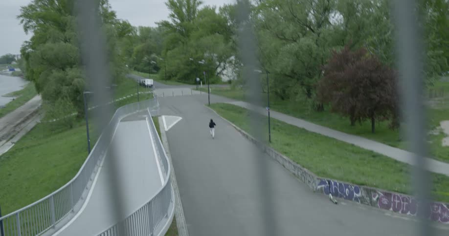 A person jogging down a road in neighborhood