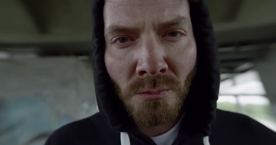 Close up of a man staring ahead and breathing hard