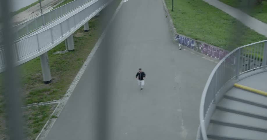 A man jobs down a public path near a lake