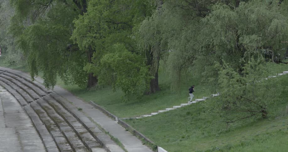 A young man runs up stairs