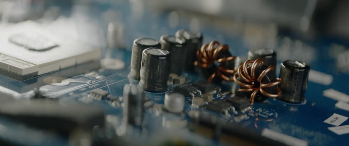 A printed circuit board has many capacitors and computer chips on its surface