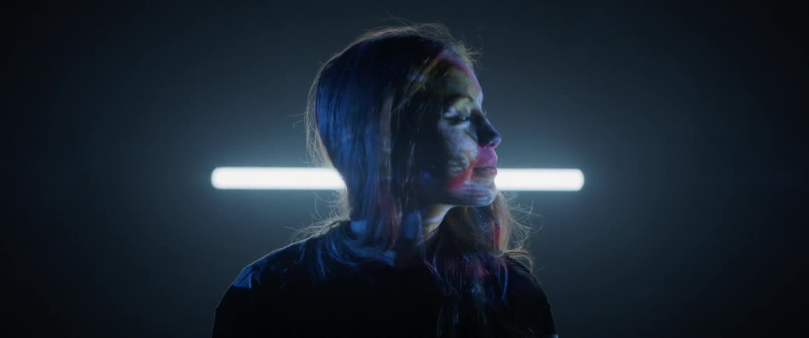 A woman is watching a projector show
