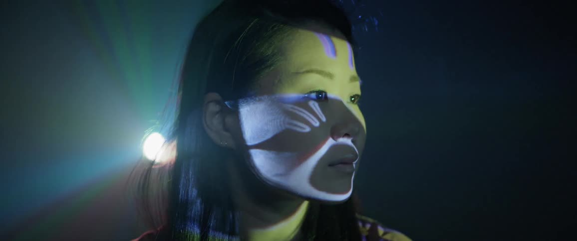 A woman is looking at a projector display