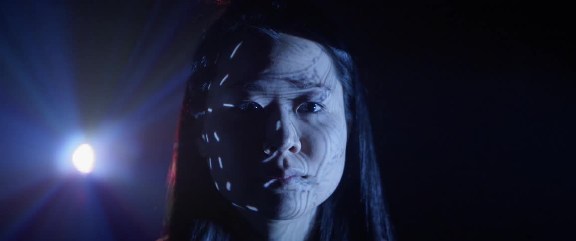 A woman watches a projector