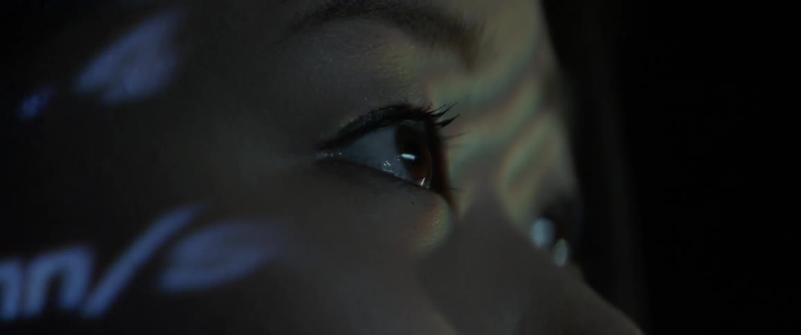 Close up of a girls eyes as she watches a screen