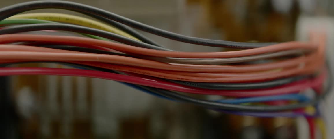Large group of multi colored wires travel in the same direction
