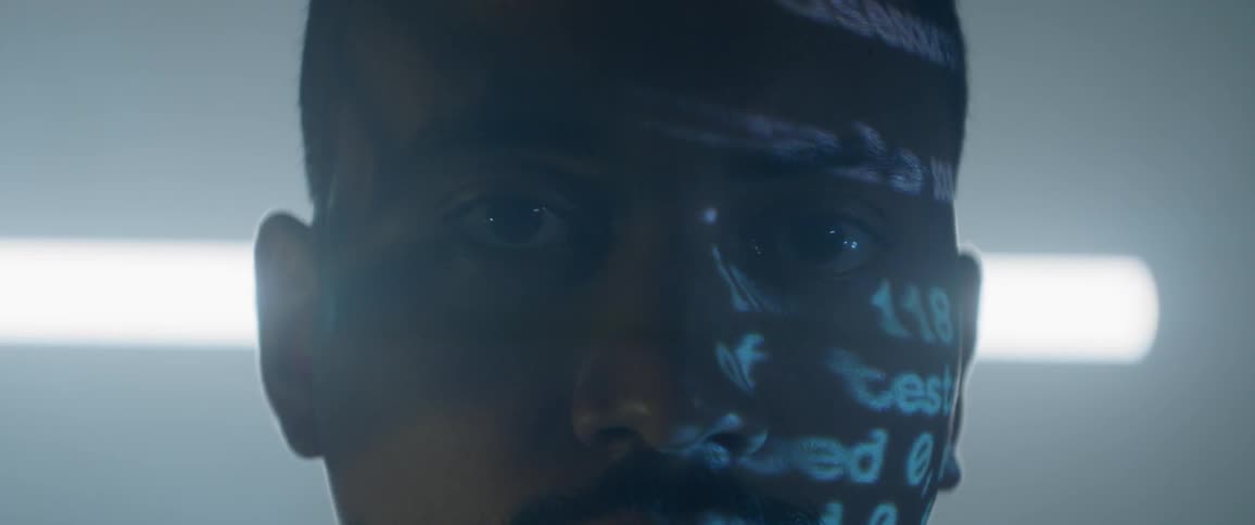 A man projects letters on his face