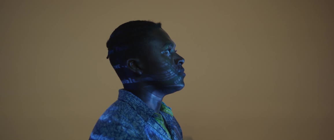 The light is flashing on the man standing still