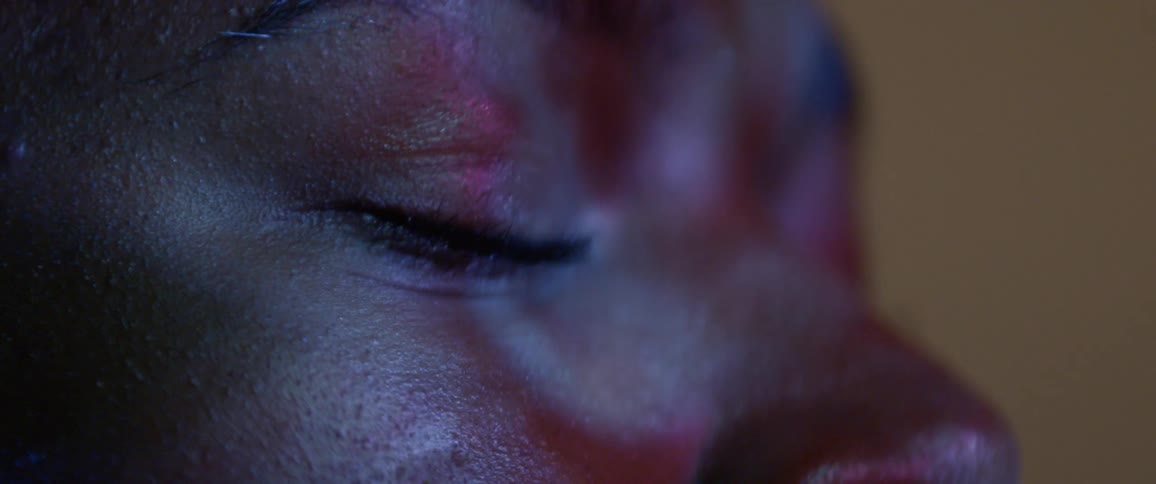 A person has lights flashing on their closed eyes