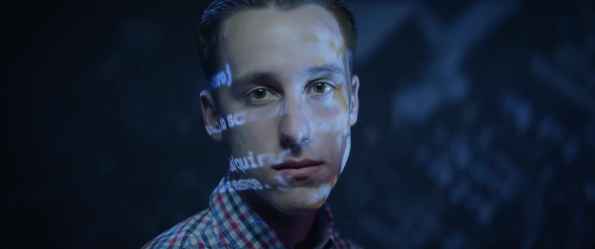 Words are projected on mans face