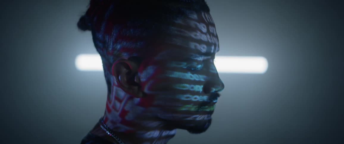 Side profile of a man with words projecting on his face