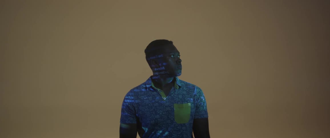 Projector light is flashing on the man