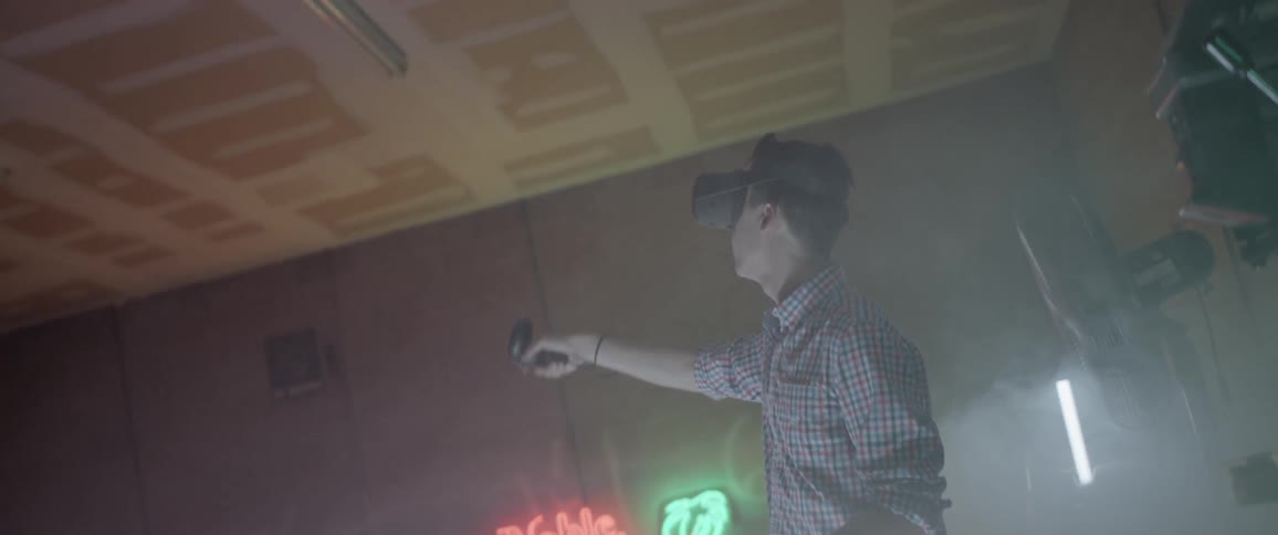 A man in a bar using a virtual reality headset
