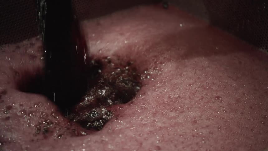 Colored liquid being poured in to a container