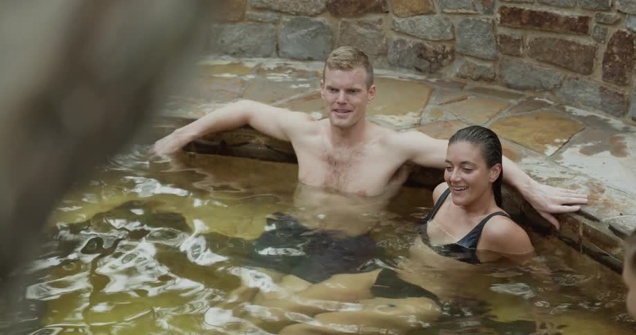 A couple sits in a hot tub and talks