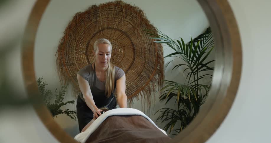 A woman massages another woman