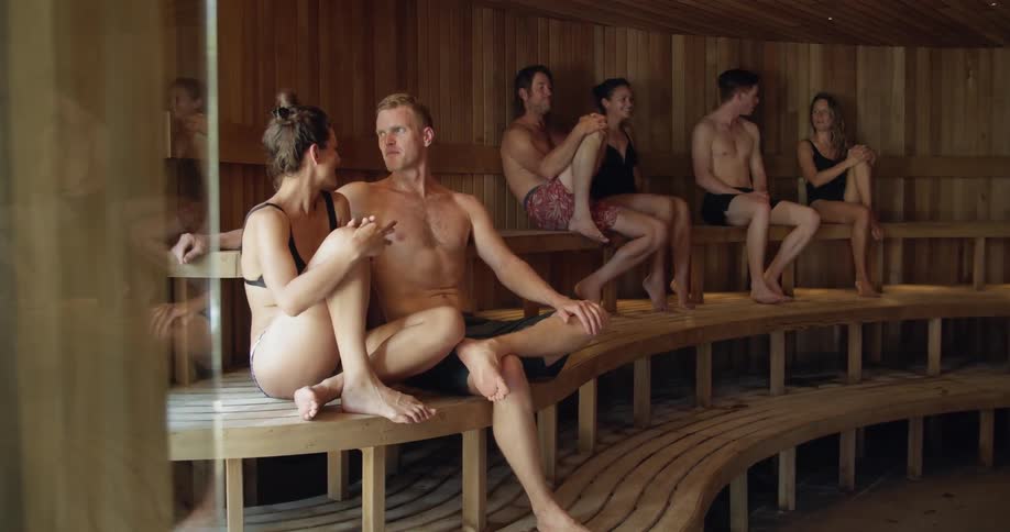 People sit and talk in a sauna