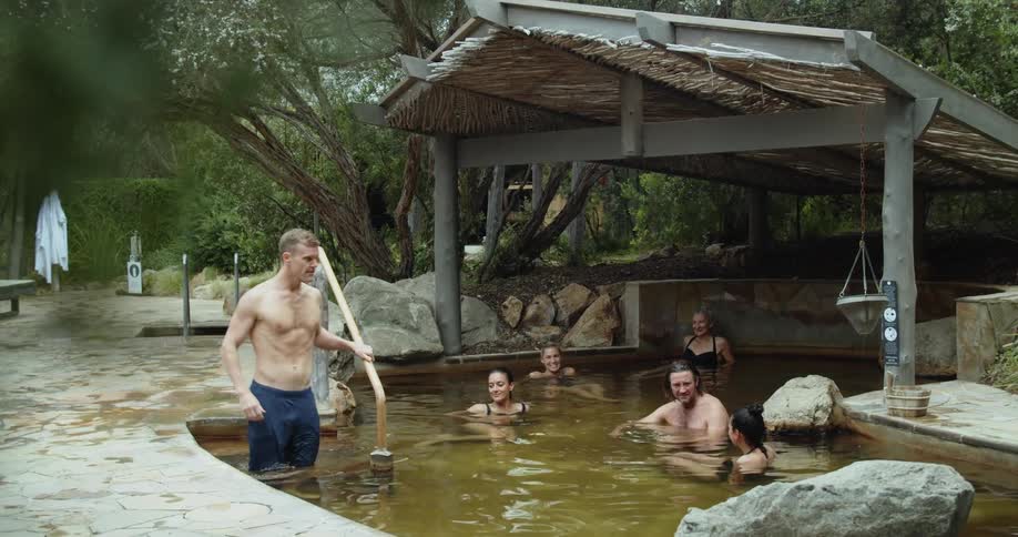 A man enters the pool with other people