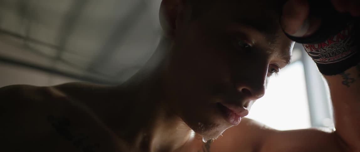 A man breathes heavily and sweats