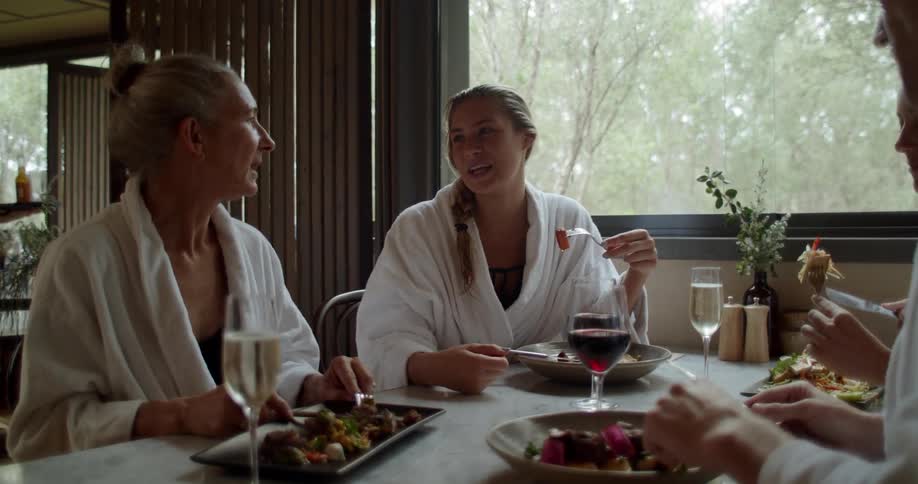 The people sit at the table eating together