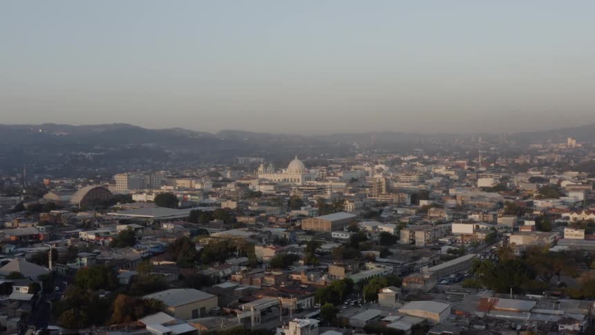 Passing over rooftops and cars traveling on city roads