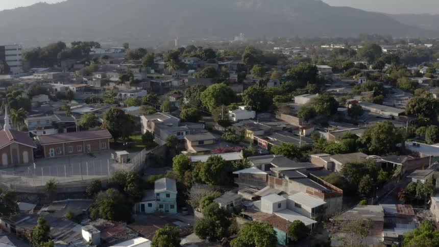 A large neighborhood spreads out in front of a mountain range