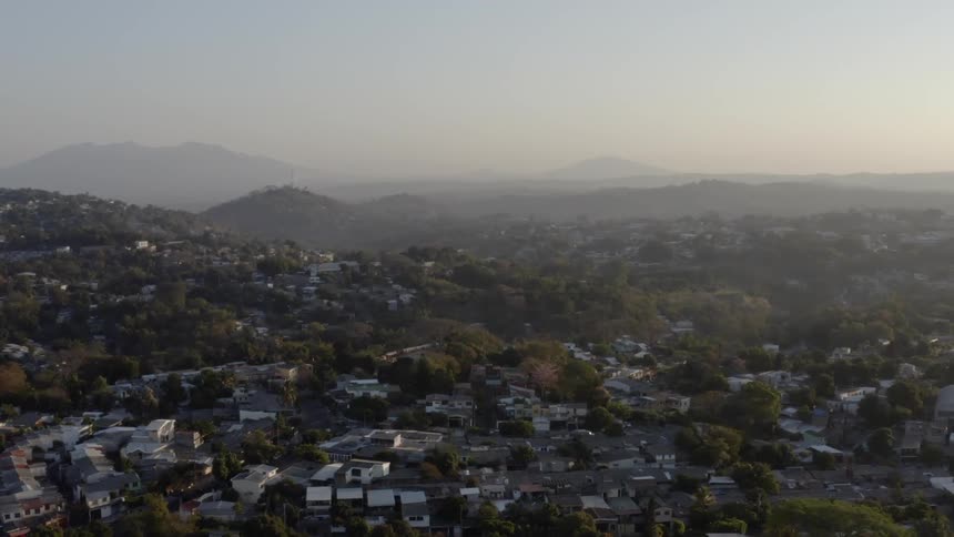 An aerial view of buildings in a hilly landscape