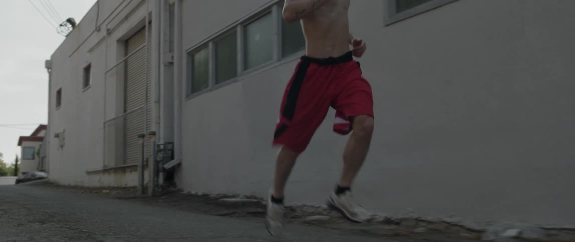 A man in red shorts running