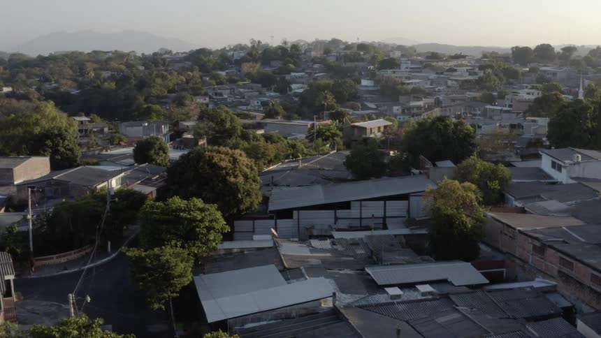 A crowded neighborhood with houses outbuildings closely spaced together