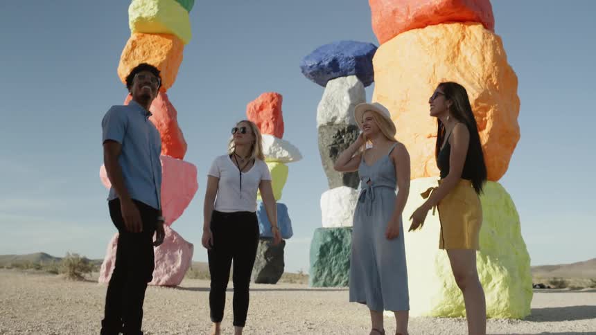 A group of friends are outdoors together and look happy