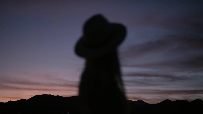 Girl standing looking at the sky