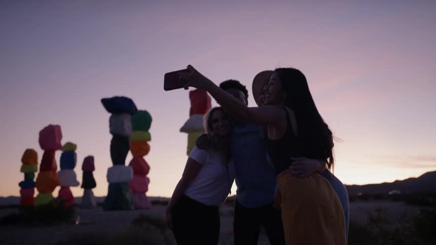 People are outdoors taking a photo together