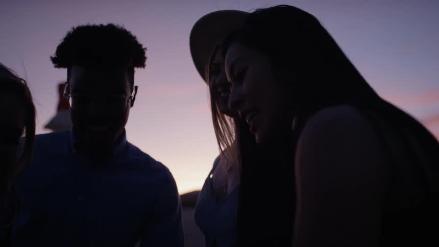 A group of people talk and hang out in the desert