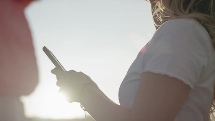 A woman grabbing a phone out of her pocket