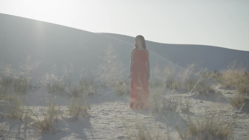 A woman walking in a desert